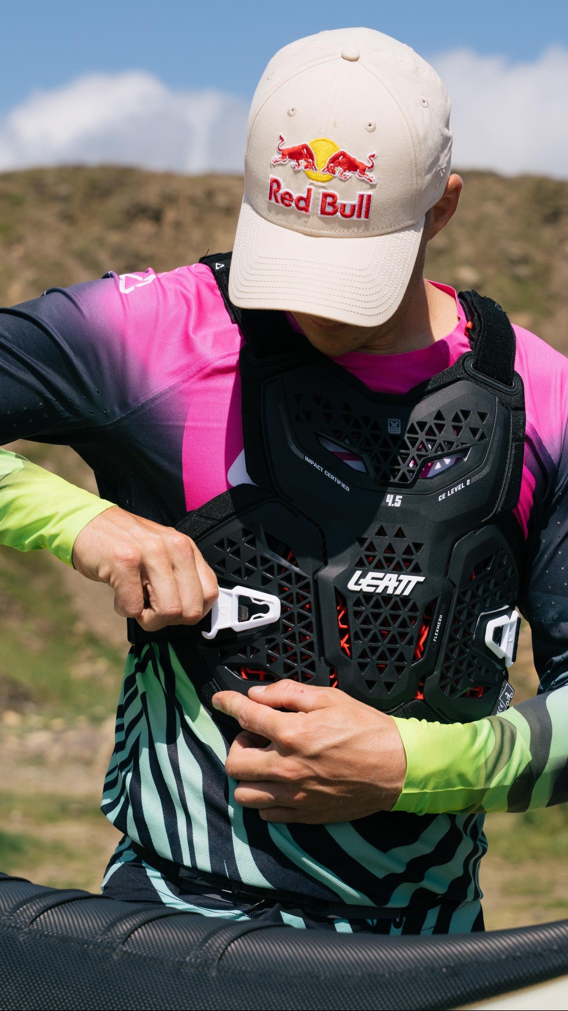 Person preparing for a bike ride with a mountainous landscape in the background