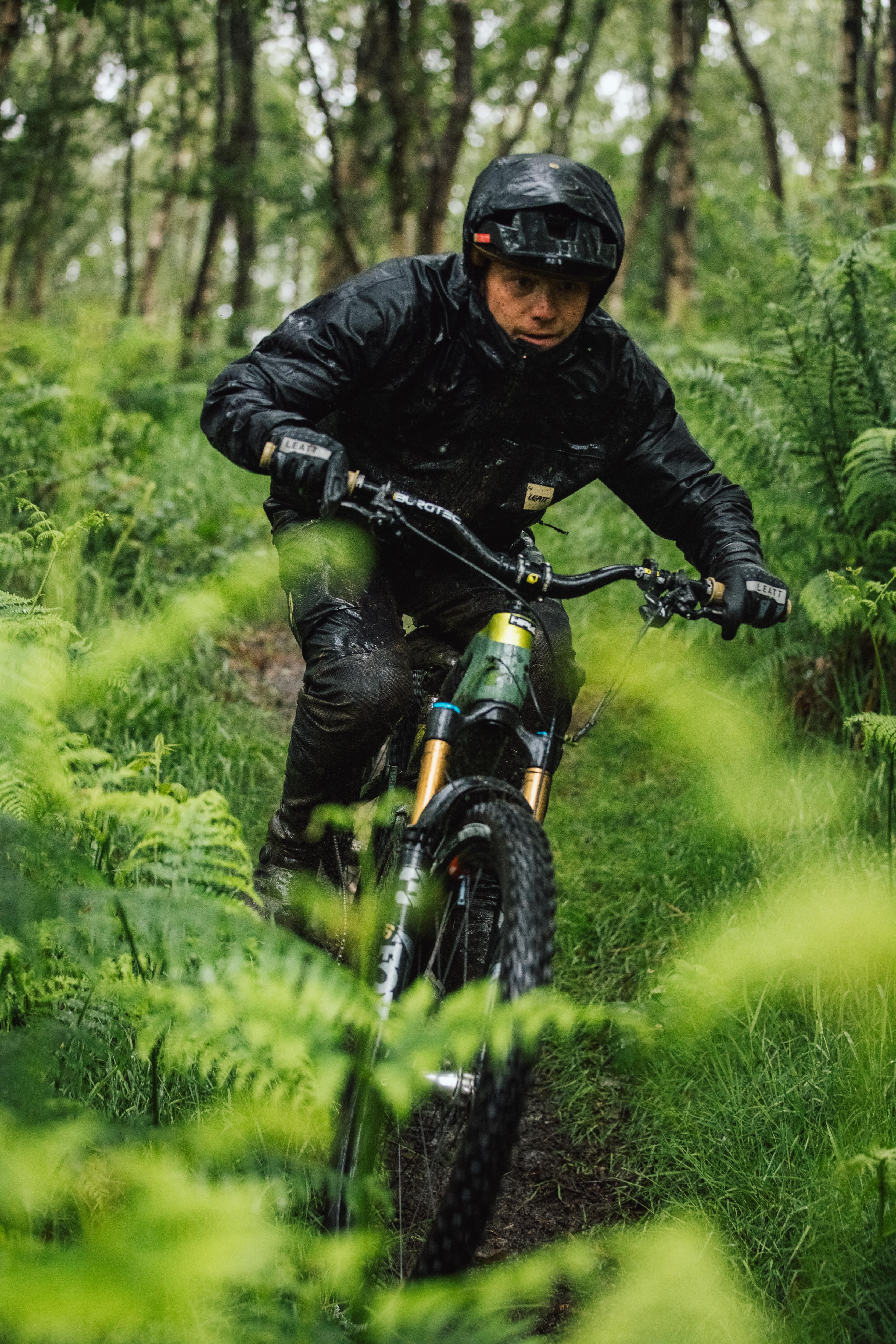 Person riding a mountain bike through a forest