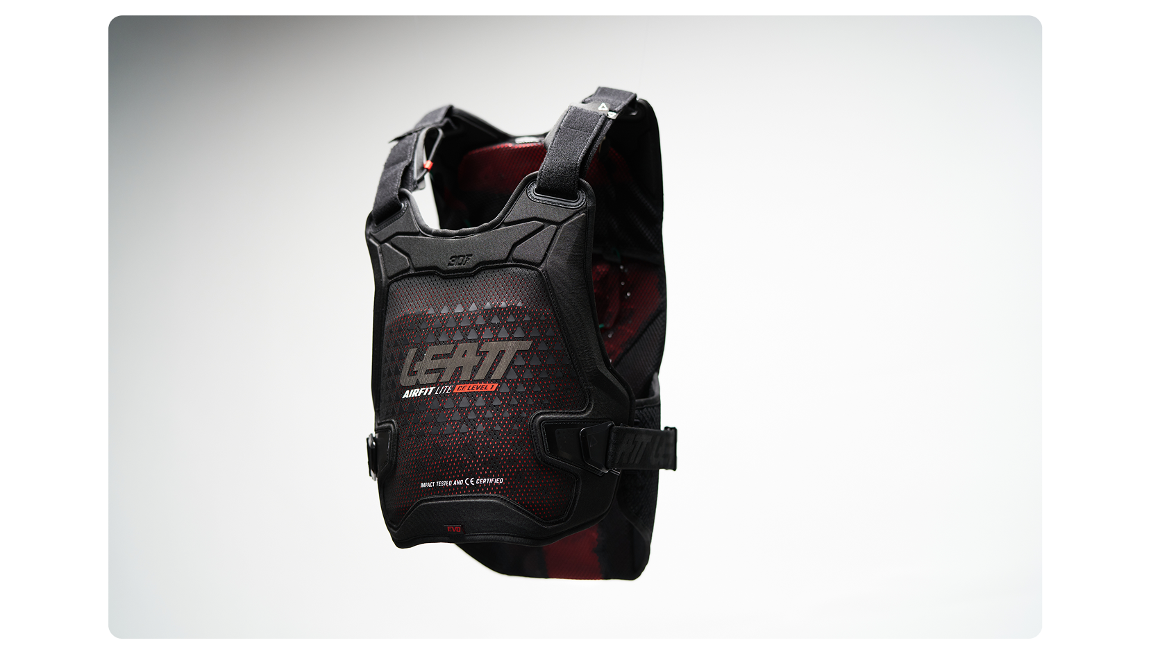 Black protective vest with red accents on a white background
