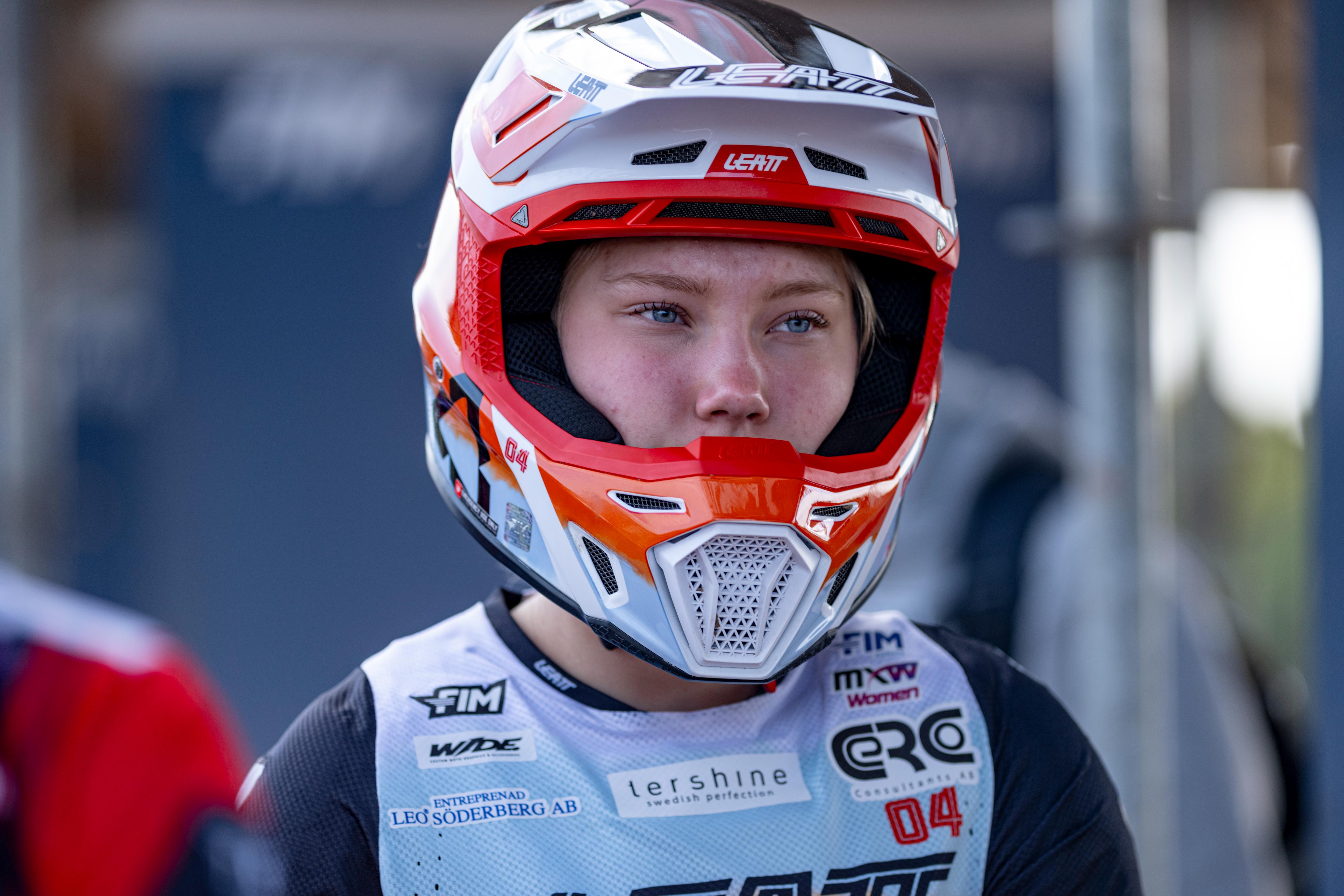Elsa wearing a red and white helmet with visible branding