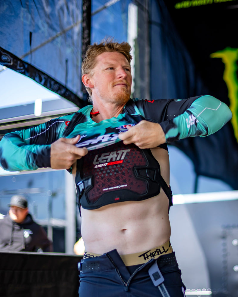 Man preparing for a race in front of a Monster Energy branded truck
