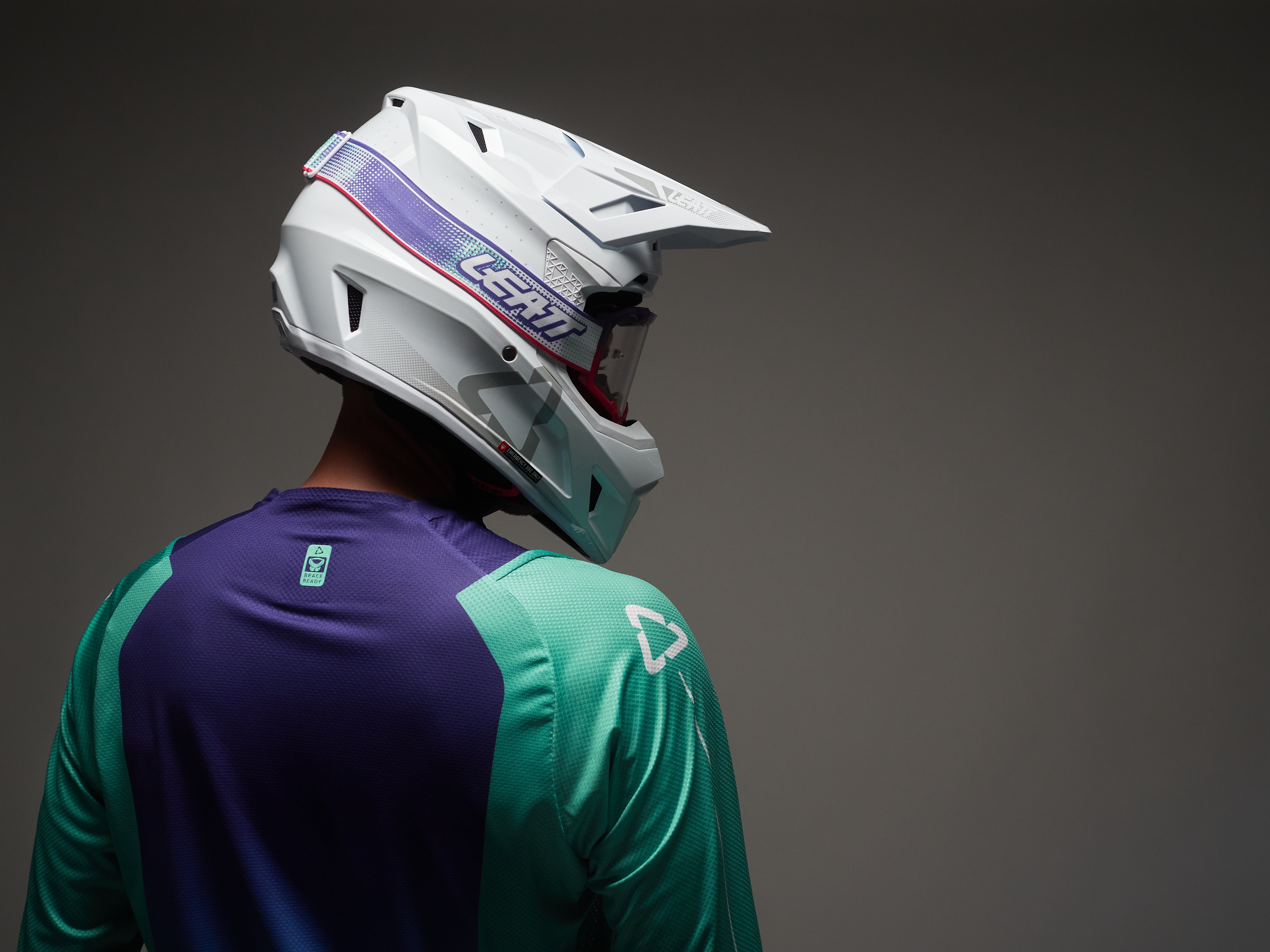 Person wearing a white helmet with a dark background