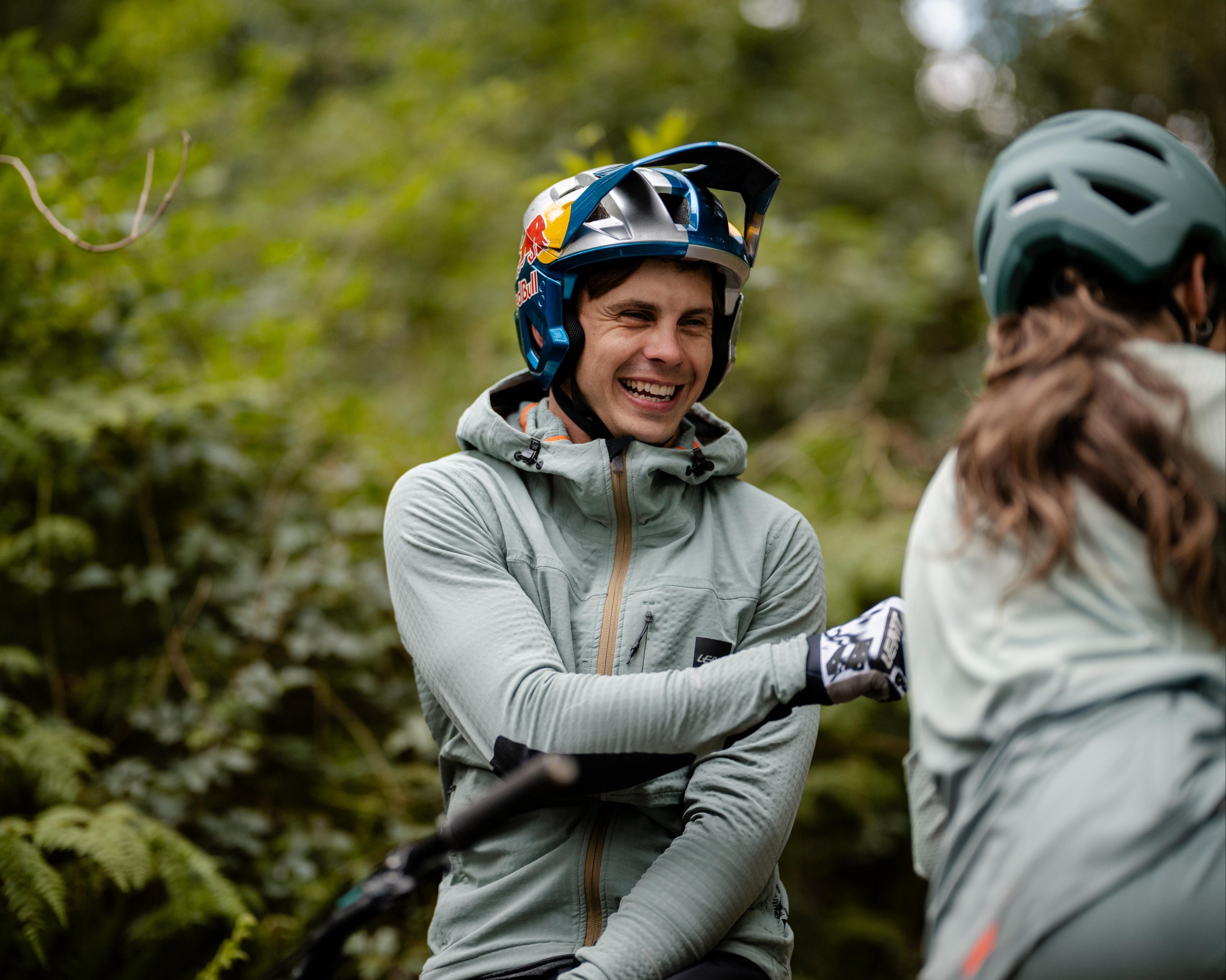 Syzmon in mountain biking gear with helmet and gloves in a forest setting