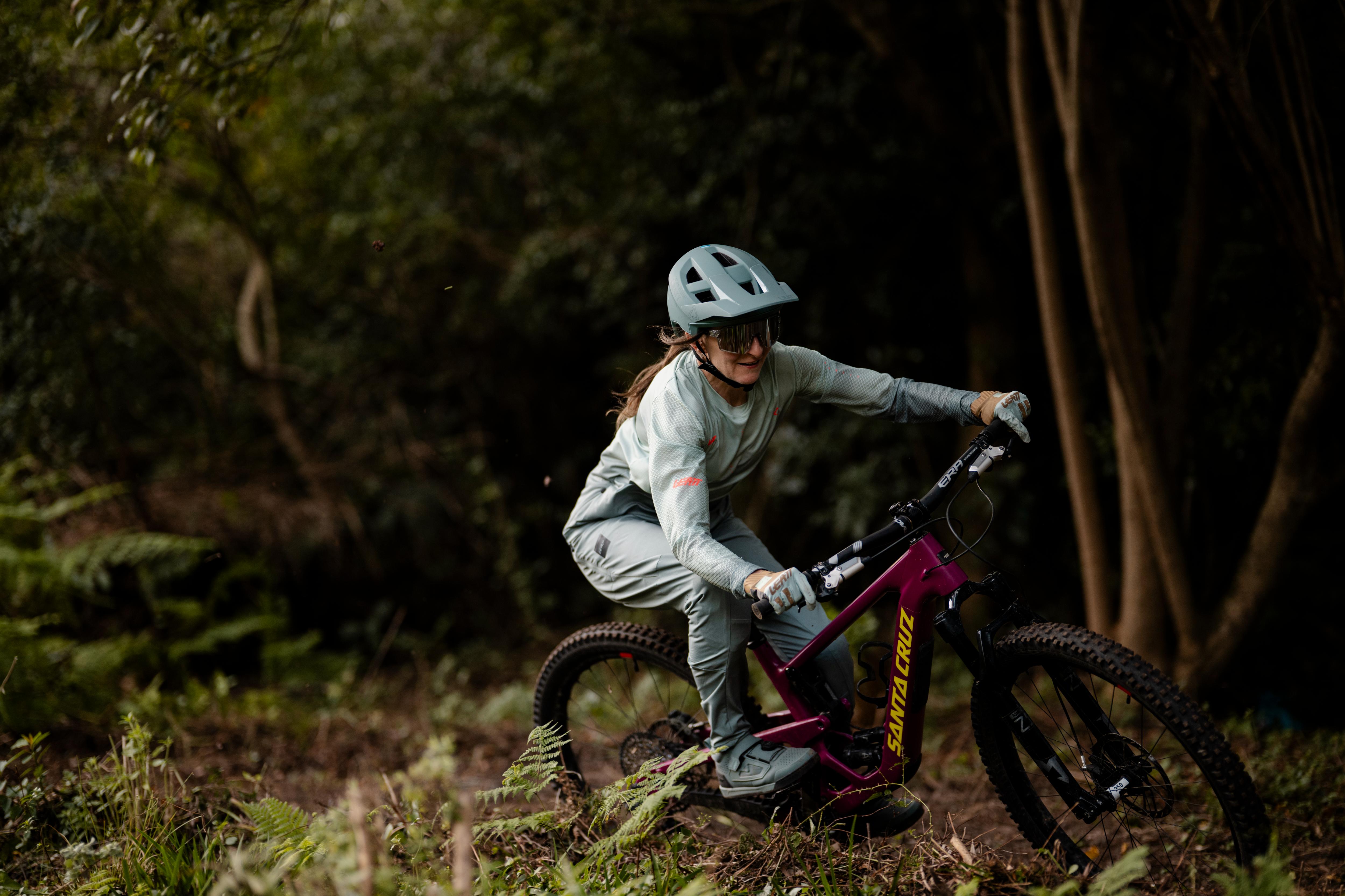 Person riding a mountain bike through a forest
