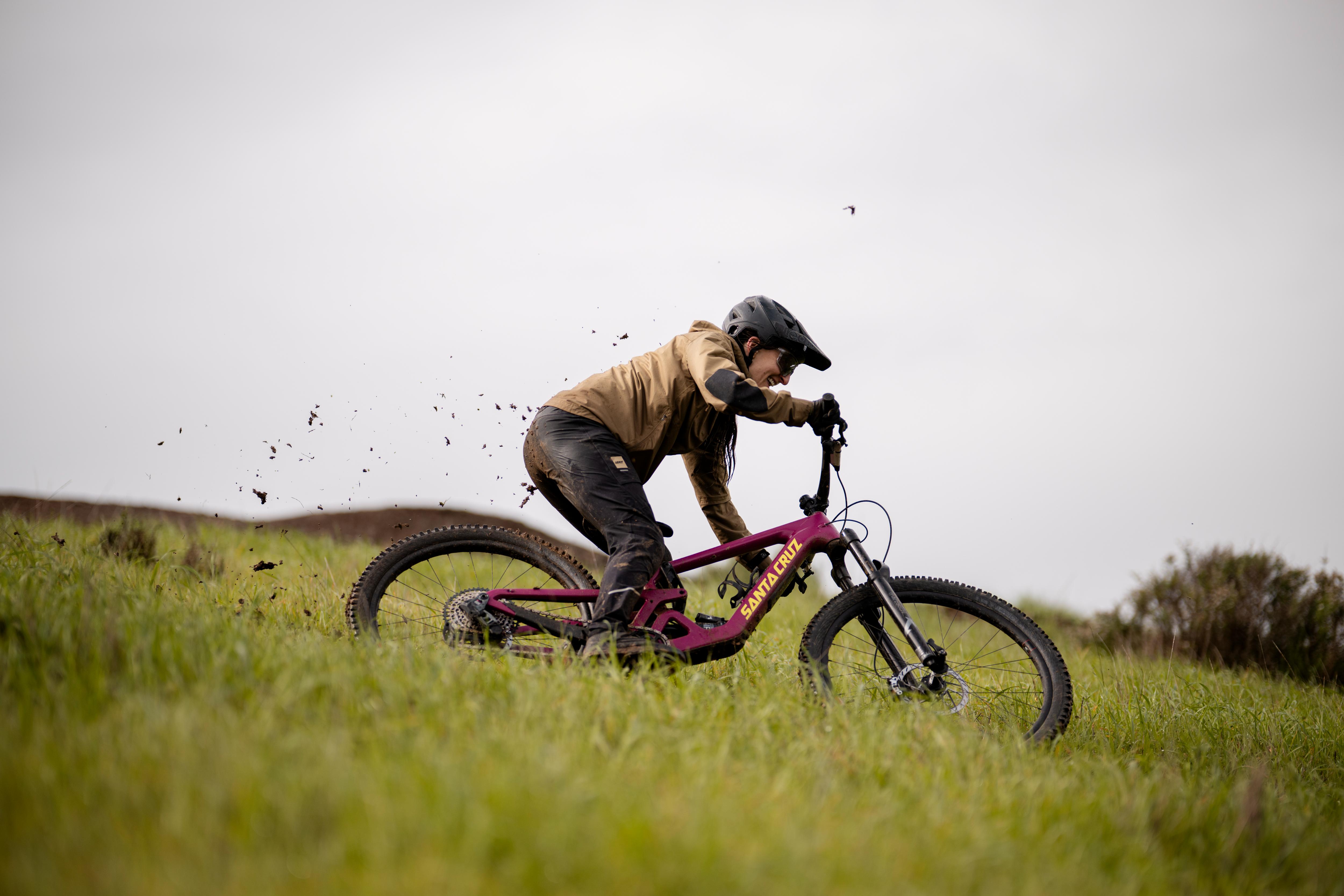Person riding a mountain bike on grass with a blurred background