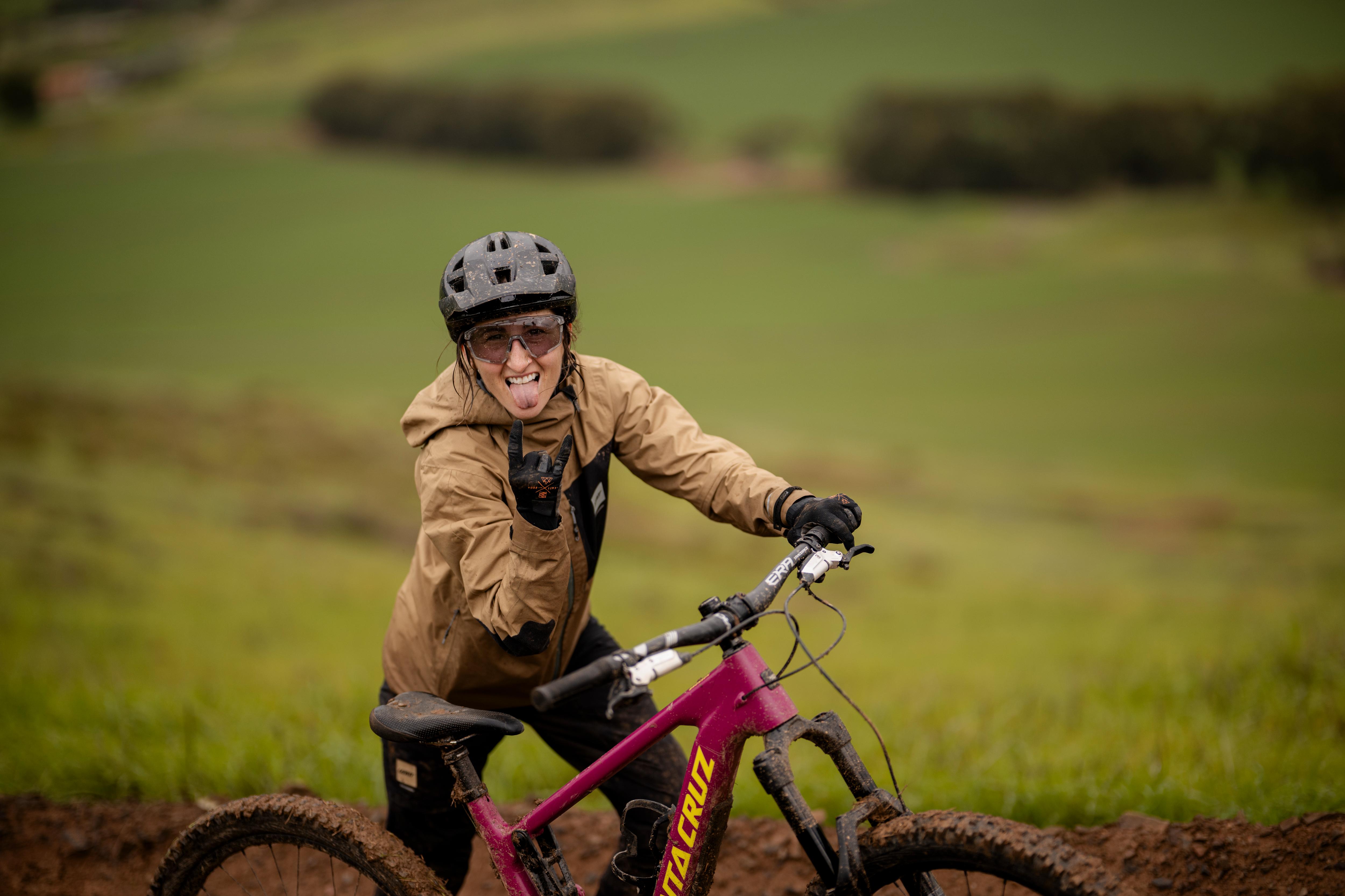 Person riding a mountain bike on a trail with a blurred natural background