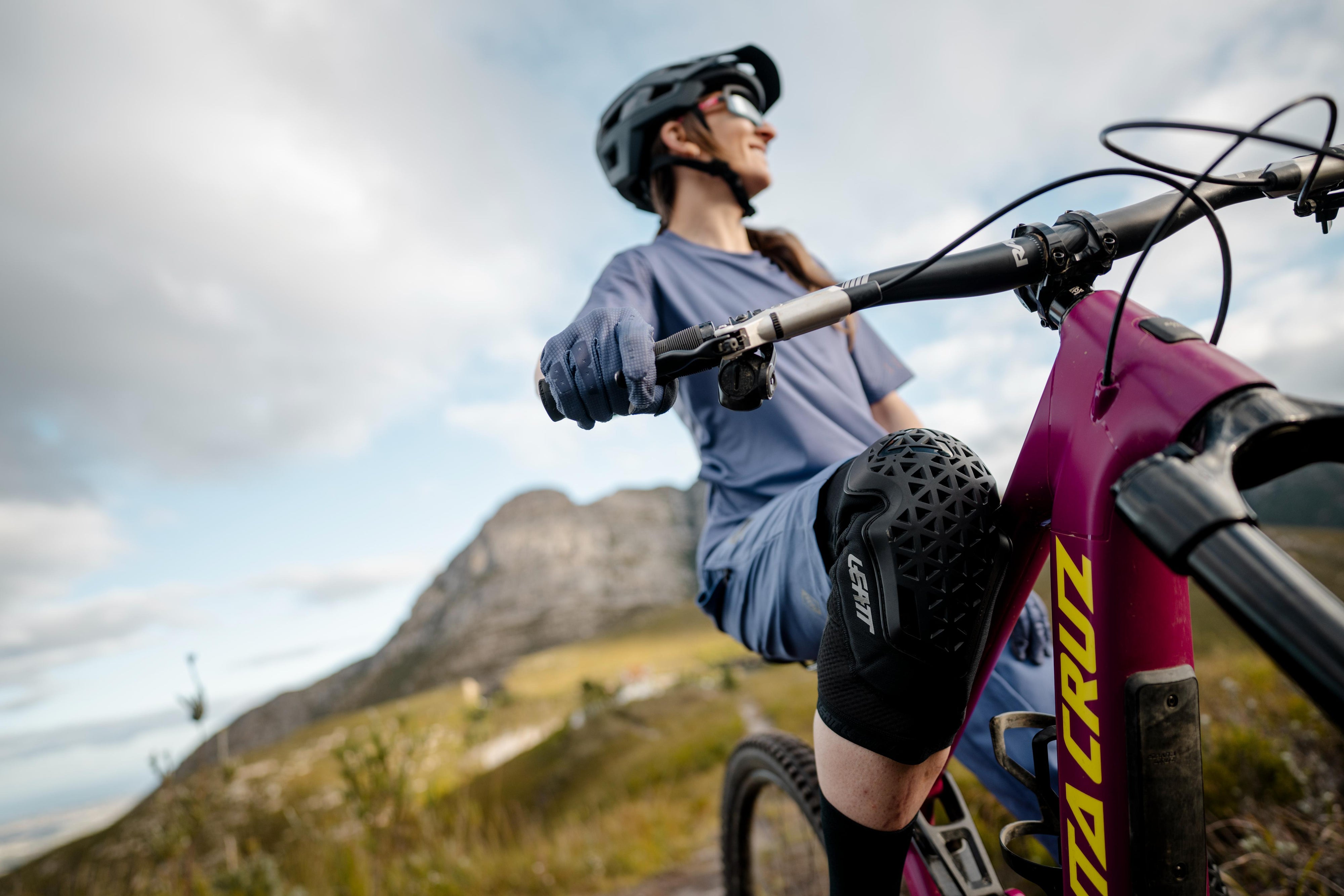 Person riding a mountain bike with a scenic background