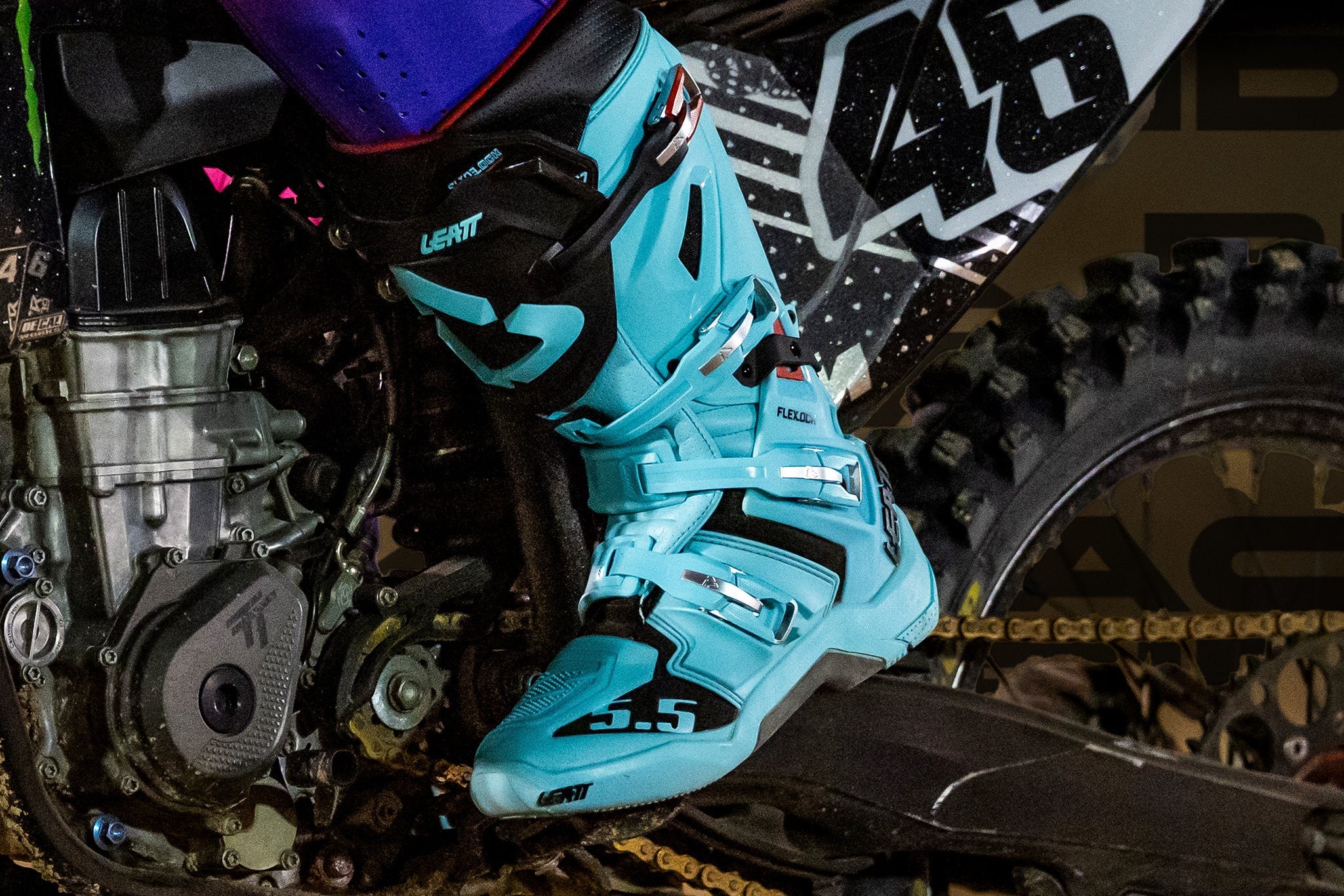 Close-up of a motocross boot on a bike with a blurred background